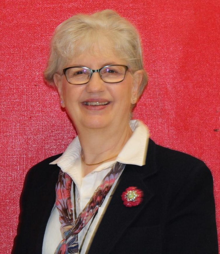 Ellen Pearsall stands outside lecture room classroom. Pearsall looks forward to the many adventures that come with retirement.