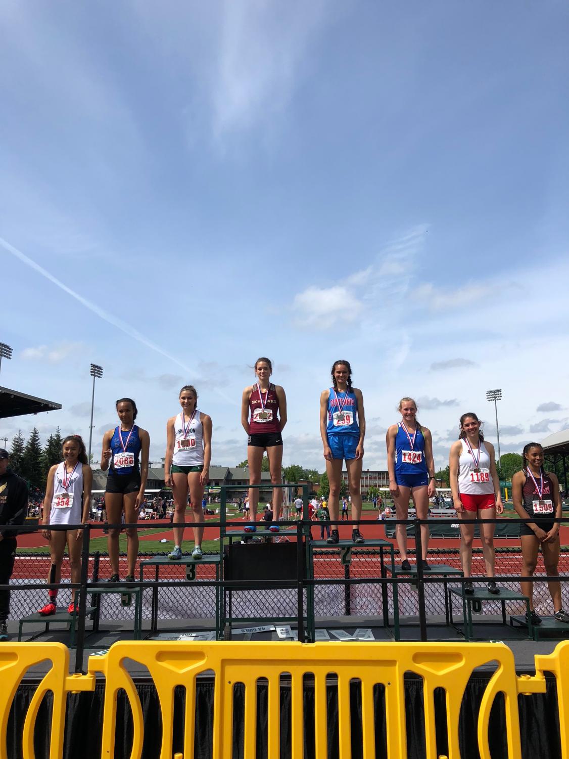 Junior Madison McHone, fifth from right to left, stands on the awards platform after one of her second place finishes last weekend.