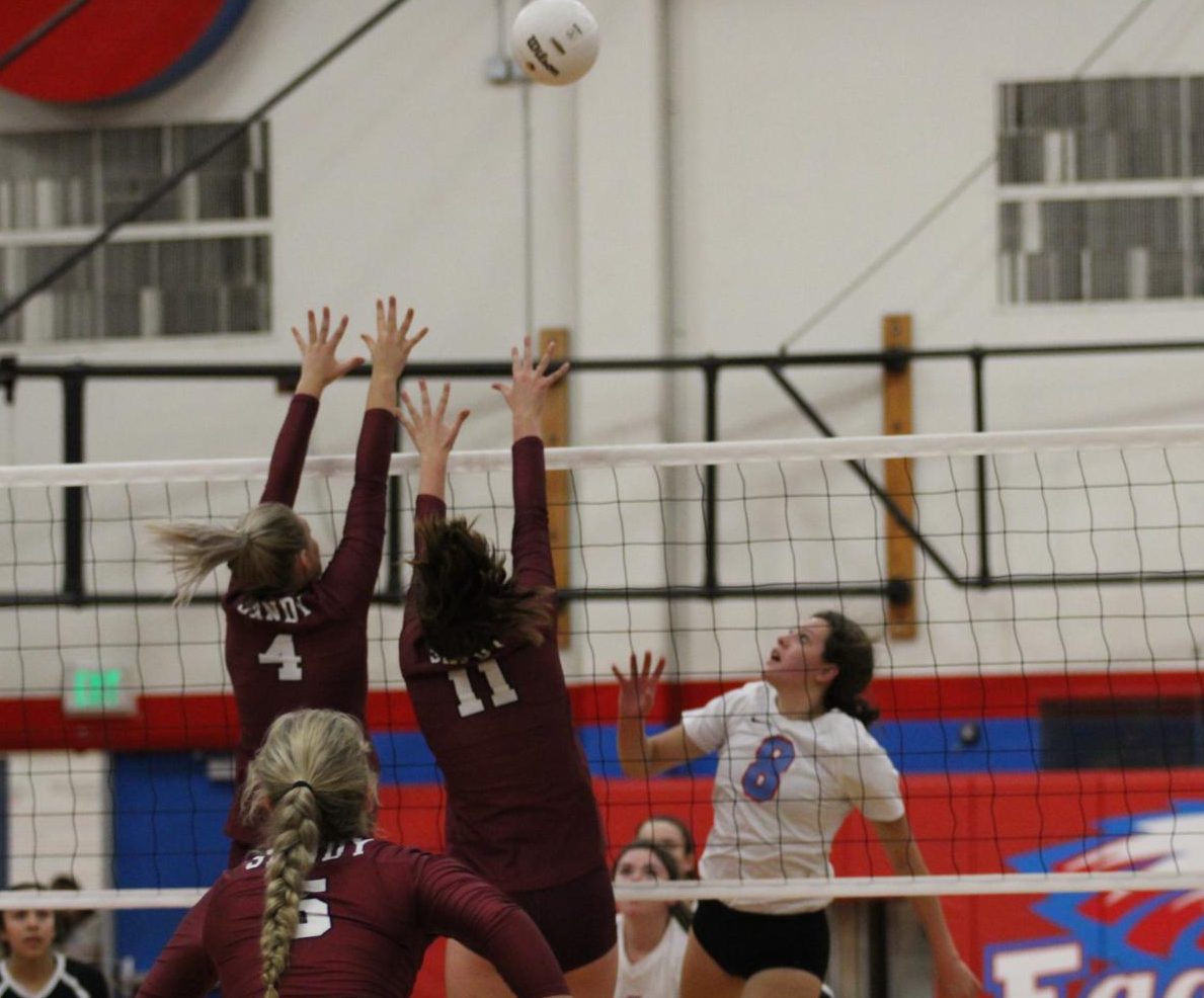 Christina Rodiriguez, number 8, and players from the other team jump for the ball. The Eagles played Clackamas last night.