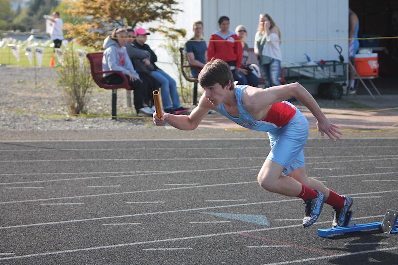 Jared+Bierbauer+explodes+out+of+the+starting+blocks+as+the+first+leg+in+the+4x100+meter+relay.+