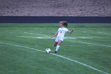 Alyssa Ronnfeldt kicks the ball to her warm up partner.