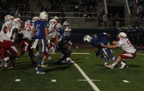 Henry Button gets the tackle in the backfield at Greshams homecoming.