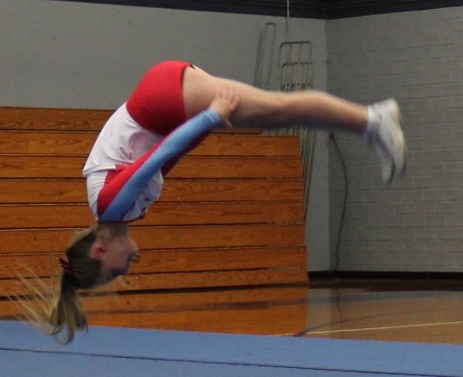 Abe Ede backflips during a cheer competition last Saturday.