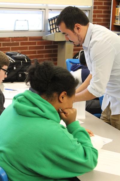 MeChA adviser Edgar Brambilia-Perez assists a student with school work.