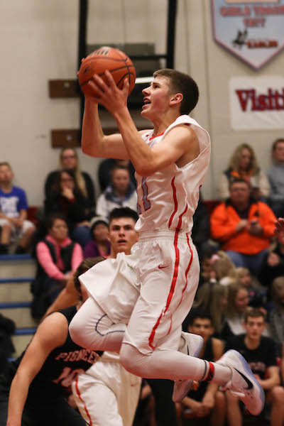 Senior Brendon Ritschard attacks the hoop. Ritschard save his best for last as he scored 23 points in the triple overtime loss at Sprague to end the season.