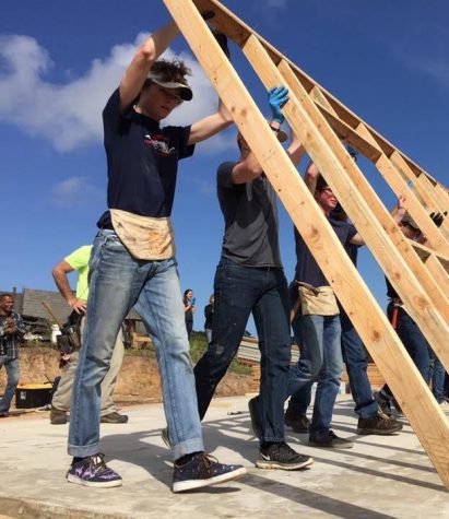 Junior John Gurney pushes up a wall for the home he helped build in Mexico over spring break. Gurney and two others from Abundant Life Church spent the week helping make life better for others.