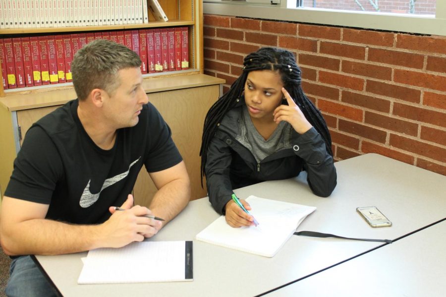 Tim Roupp chats with student Nae Nae Glass about school work. Roupp found his day shadowing a student to be very rewarding.