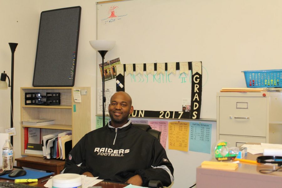 Damein Roache works at his desk. Roache is excited about the current sun courses that are available.