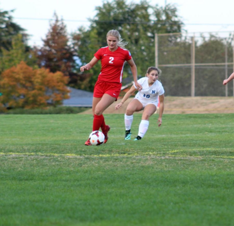Chloe Smith runs across the field with the ball. The girls soccer team plays Sandy at 7 on Thursday.