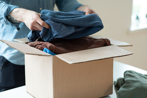 Volunteer with donation box with clothes