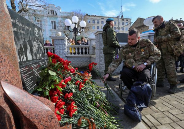 People put flowers at the newly opened memorial to Russian service members killed during Russia-Ukraine conflict, in Yevpatoriya, Crimea February 22, 2024. REUTERS/Alexey Pavlishak